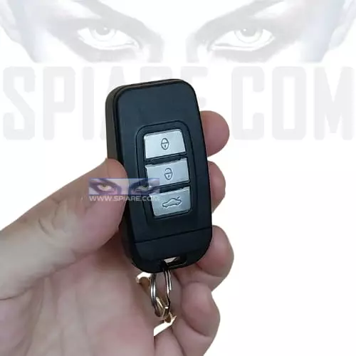 Portachiavi spia a forma di telecomando auto tenuto in mano per evidenziarne la mimetizzazione e le dimensioni ridotte